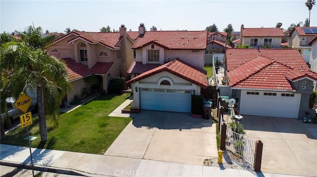 13117 Pan Am Blvd, Moreno Valley, CA 92553 - mediterranean / spanish-style home with driveway, a residential view, a tiled roof, and stucco siding