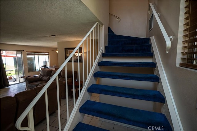 13117 Pan Am Blvd, Moreno Valley, CA 92553 - stairs with tile patterned floors and a textured ceiling
