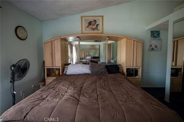 13117 Pan Am Blvd, Moreno Valley, CA 92553 - bedroom featuring lofted ceiling, carpet flooring, arched walkways, and a textured ceiling