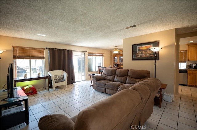 13117 Pan Am Blvd, Moreno Valley, CA 92553 - living area with light tile patterned floors, ceiling fan, and a textured ceiling