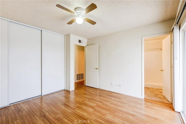 23719 White Owl Ct, Moreno Valley, CA 92553 - unfurnished bedroom featuring a textured ceiling, wood finished floors, a closet, and ceiling fan