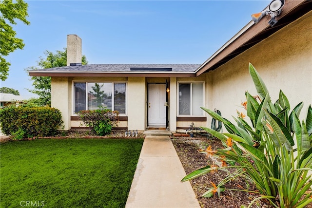 23719 White Owl Ct, Moreno Valley, CA 92553 - property entrance featuring stucco siding and a lawn
