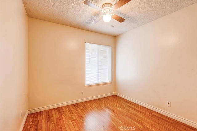 23719 White Owl Ct, Moreno Valley, CA 92553 - empty room with a textured ceiling, wood finished floors, baseboards, and ceiling fan