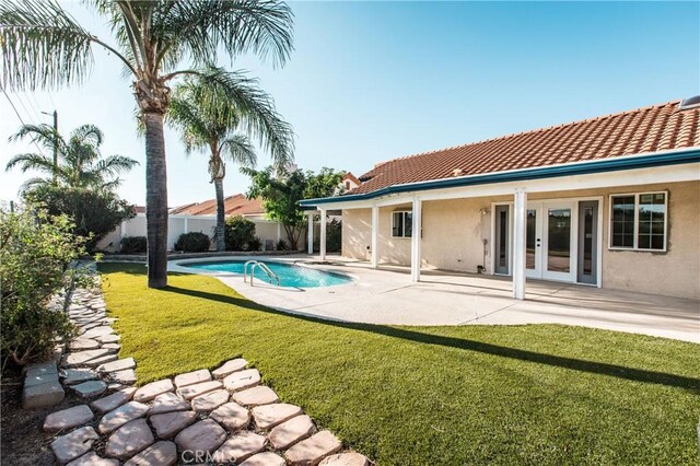 view of swimming pool with french doors and a patio area