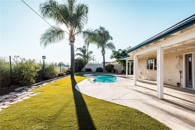 view of swimming pool with a patio area