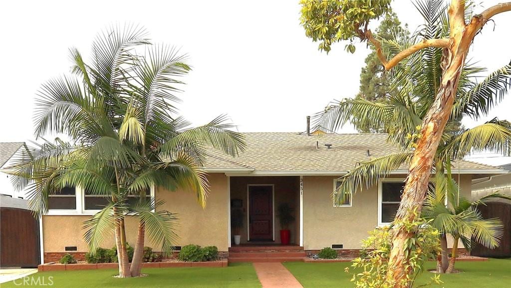 3451 Monogram Ave, Long Beach, CA 90808 - view of front of home featuring stucco siding, a shingled roof, and a front lawn