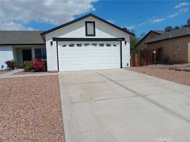 17795 Stevens Rd, Adelanto, CA 92301 - ranch-style house featuring fence, driveway, an attached garage, and stucco siding