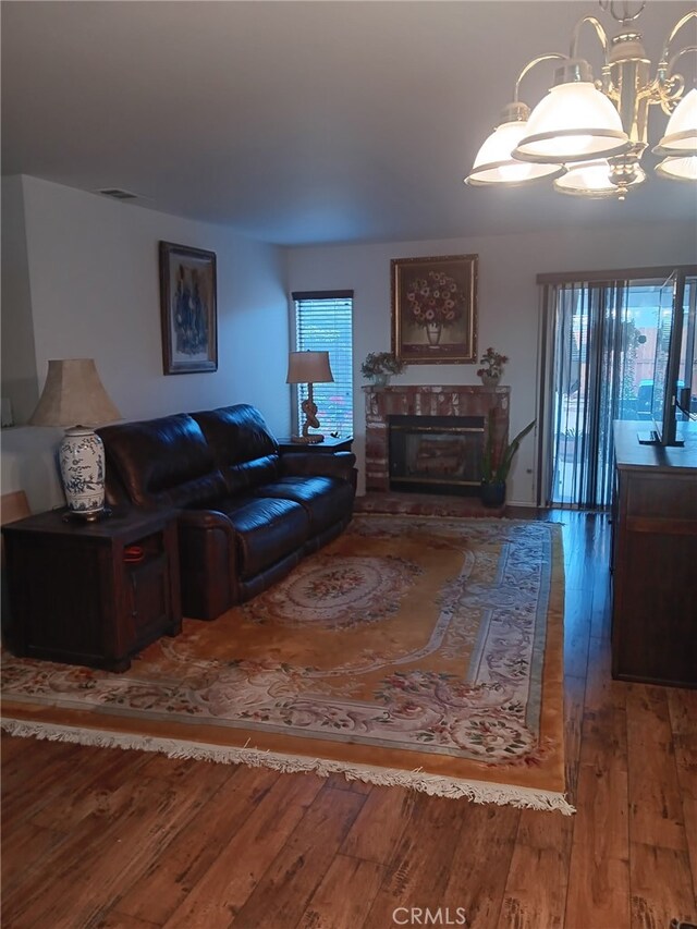 17795 Stevens Rd, Adelanto, CA 92301 - living room with hardwood / wood-style floors, a glass covered fireplace, and a chandelier