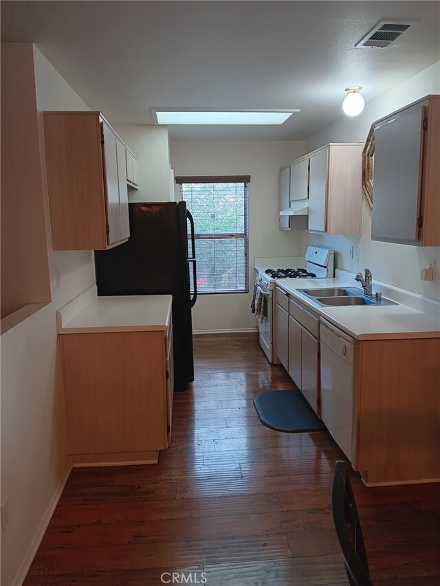 17795 Stevens Rd, Adelanto, CA 92301 - kitchen featuring white appliances, under cabinet range hood, a sink, dark wood-type flooring, and light countertops