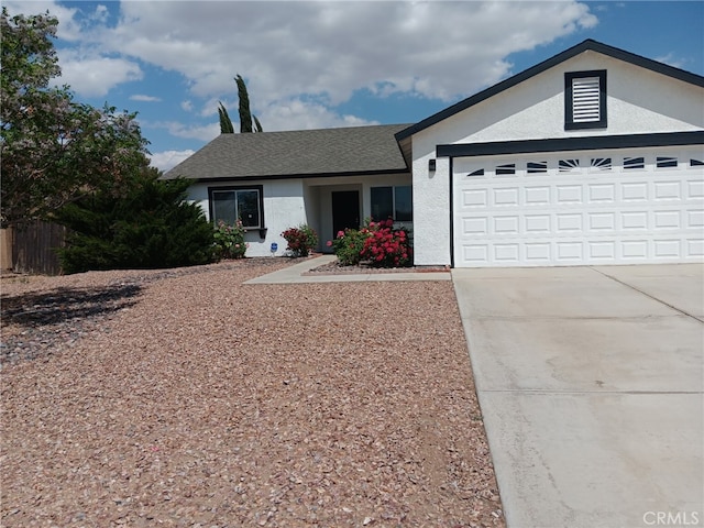 17795 Stevens Rd, Adelanto, CA 92301 - ranch-style house with concrete driveway, a garage, and stucco siding