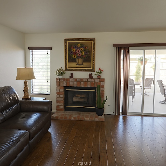 17795 Stevens Rd, Adelanto, CA 92301 - living area with dark wood-type flooring, a brick fireplace, and baseboards