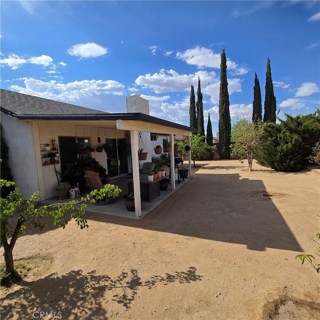 17795 Stevens Rd, Adelanto, CA 92301 - back of house featuring a patio, a chimney, and stucco siding