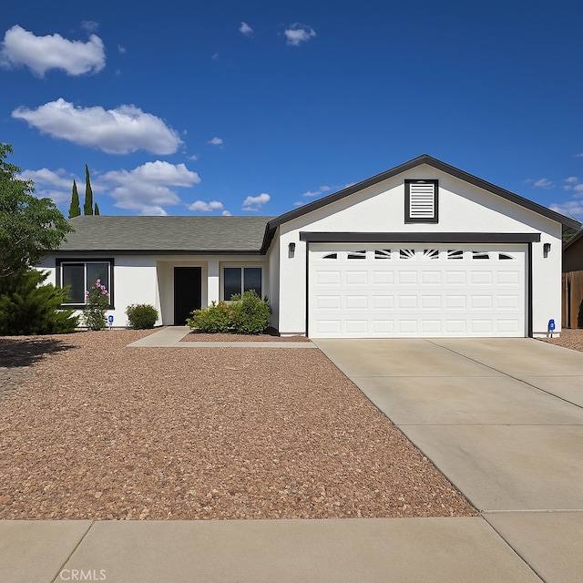 17795 Stevens Rd, Adelanto, CA 92301 - ranch-style house with a garage, driveway, and stucco siding