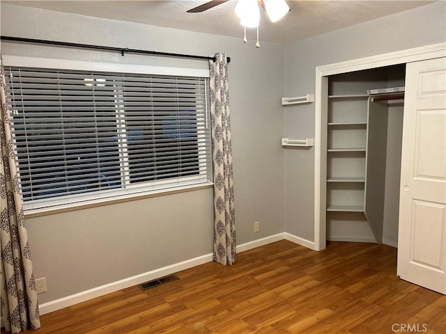 14749 Vassar Ct, Magalia, CA 95954 - unfurnished bedroom featuring wood finished floors, baseboards, a closet, and a ceiling fan