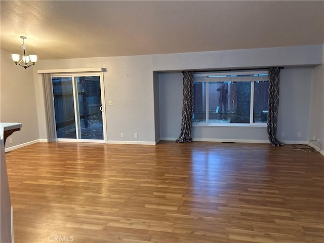 14749 Vassar Ct, Magalia, CA 95954 - empty room with a chandelier, wood finished floors, and baseboards