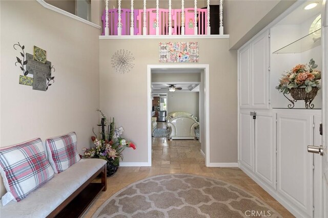 13545 Anchor Dr, Victorville, CA 92395 - foyer entrance featuring baseboards, a ceiling fan, and light stone finish flooring