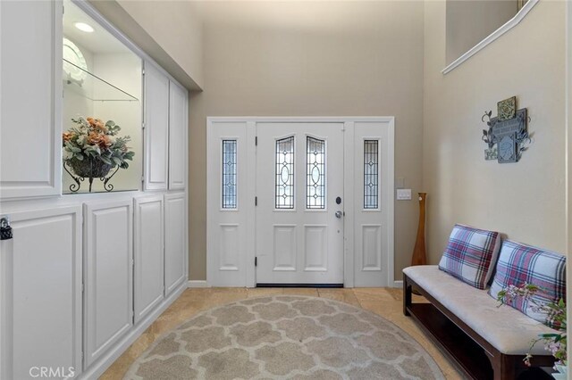 13545 Anchor Dr, Victorville, CA 92395 - foyer with a high ceiling, baseboards, and light tile patterned floors