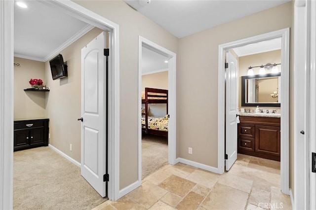 13545 Anchor Dr, Victorville, CA 92395 - hall featuring crown molding, baseboards, light colored carpet, stone tile flooring, and a sink