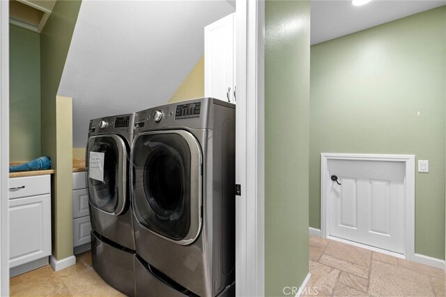 13545 Anchor Dr, Victorville, CA 92395 - laundry room featuring washing machine and dryer, baseboards, cabinet space, and stone tile flooring