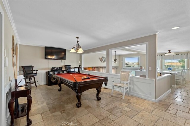 13545 Anchor Dr, Victorville, CA 92395 - recreation room with stone tile floors, crown molding, billiards table, a wainscoted wall, and a decorative wall