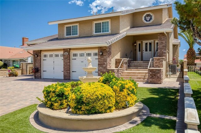 13545 Anchor Dr, Victorville, CA 92395 - view of front of property with stucco siding, decorative driveway, a gate, and a garage