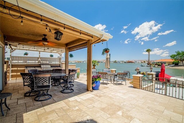 13545 Anchor Dr, Victorville, CA 92395 - view of patio featuring outdoor dining area, ceiling fan, and a water view