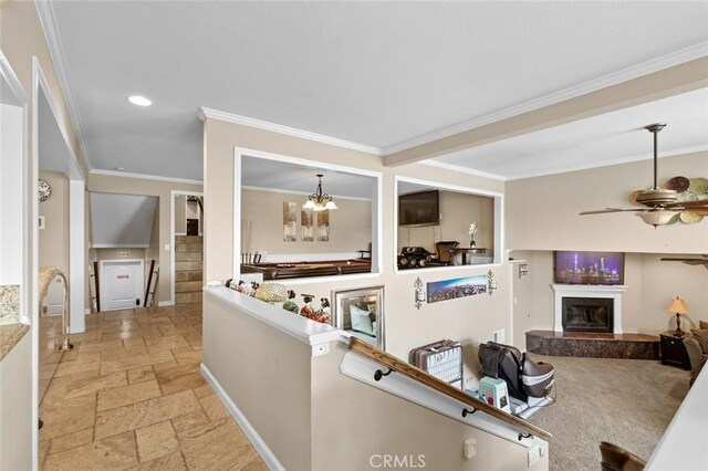 13545 Anchor Dr, Victorville, CA 92395 - living room featuring stone tile flooring, ceiling fan, crown molding, recessed lighting, and a glass covered fireplace
