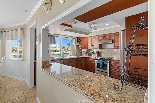 13545 Anchor Dr, Victorville, CA 92395 - kitchen featuring appliances with stainless steel finishes, under cabinet range hood, crown molding, stone tile floors, and healthy amount of natural light