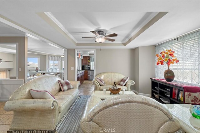 13545 Anchor Dr, Victorville, CA 92395 - living room with ceiling fan, crown molding, a raised ceiling, and baseboards
