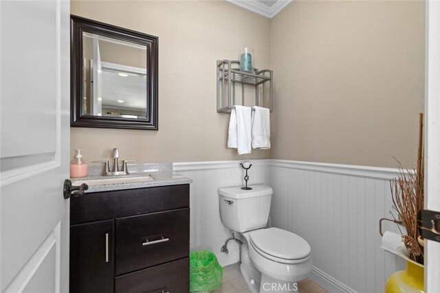 13545 Anchor Dr, Victorville, CA 92395 - bathroom with toilet, wainscoting, vanity, and crown molding