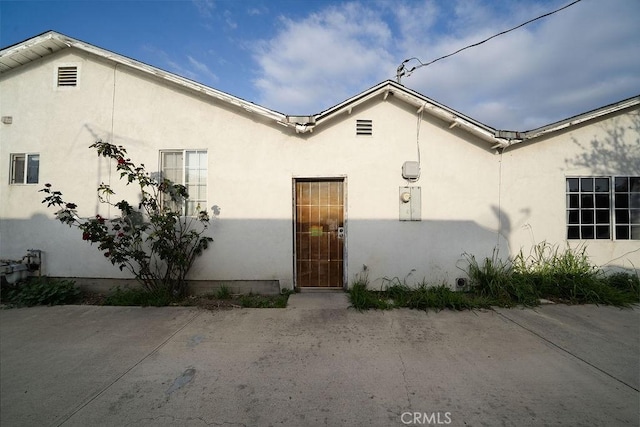 doorway to property with stucco siding