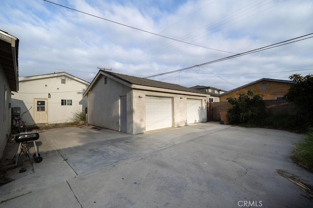 detached garage featuring fence