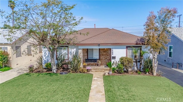 1933 W 147th St, Gardena, CA 90249 - view of front of house with a front yard, stucco siding, and a shingled roof