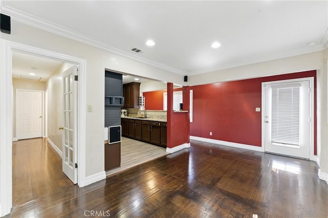 1933 W 147th St, Gardena, CA 90249 - kitchen featuring wood finished floors, ornamental molding, baseboards, a sink, and dark brown cabinets