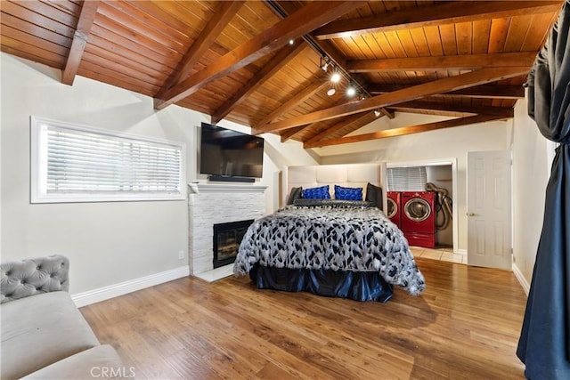 1933 W 147th St, Gardena, CA 90249 - bedroom with independent washer and dryer, wooden ceiling, baseboards, wood finished floors, and a stone fireplace
