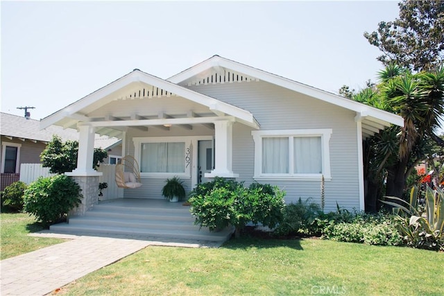 view of front of house with covered porch and a front yard
