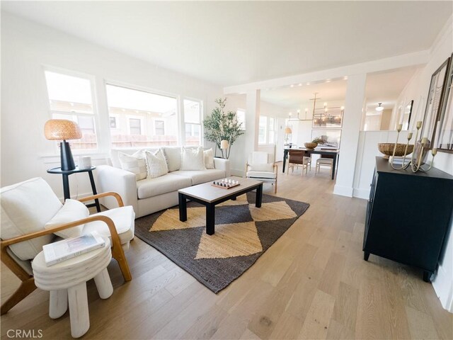 living room featuring light wood-style floors and a chandelier