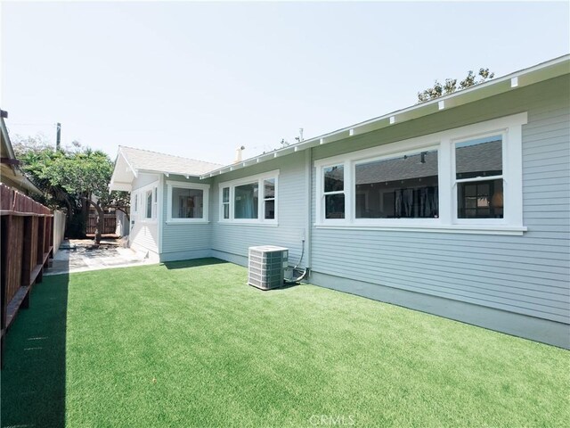 back of house with central AC unit