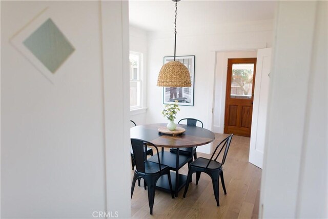 dining space with light wood finished floors