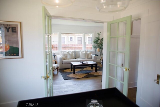 hallway featuring french doors and wood finished floors