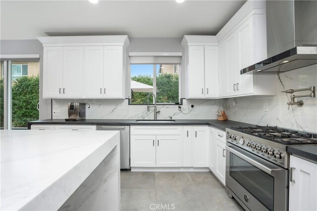 23148 W Saratoga Way, West Hills, CA 91307 - kitchen featuring wall chimney range hood, a sink, stainless steel appliances, dark countertops, and recessed lighting