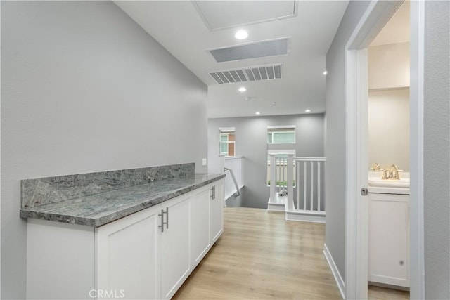 23148 W Saratoga Way, West Hills, CA 91307 - hall with an upstairs landing, light wood-style flooring, and a sink