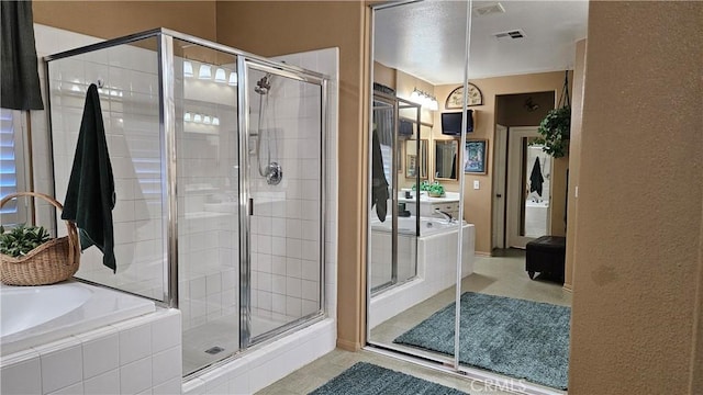 bathroom featuring a shower stall and a garden tub