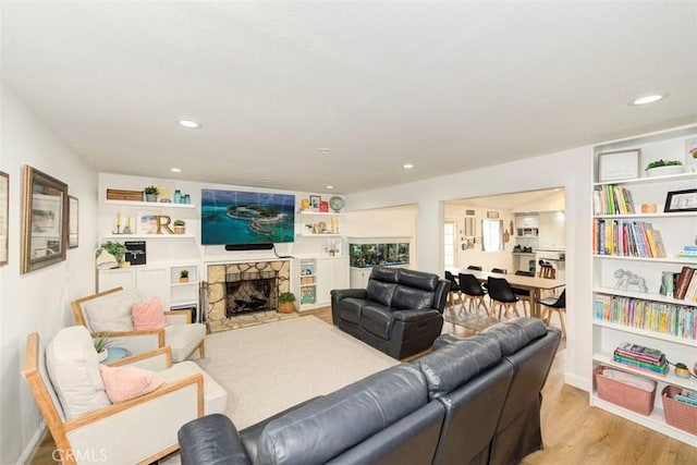 1417 E Abbottson St, Carson, CA 90746 - living room with light wood-style flooring, a fireplace, and recessed lighting