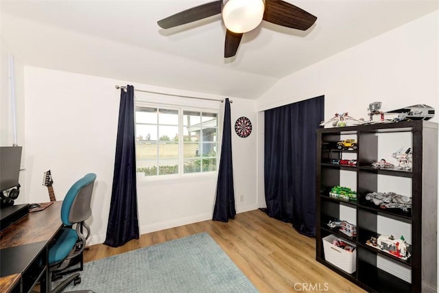 home office featuring a ceiling fan, wood finished floors, vaulted ceiling, and baseboards