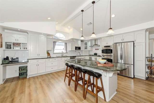 1417 E Abbottson St, Carson, CA 90746 - kitchen featuring appliances with stainless steel finishes, wall chimney range hood, a sink, a kitchen breakfast bar, and white cabinetry