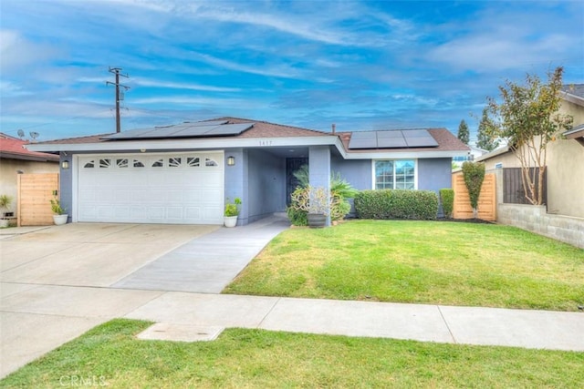 single story home featuring solar panels, driveway, a garage, and stucco siding