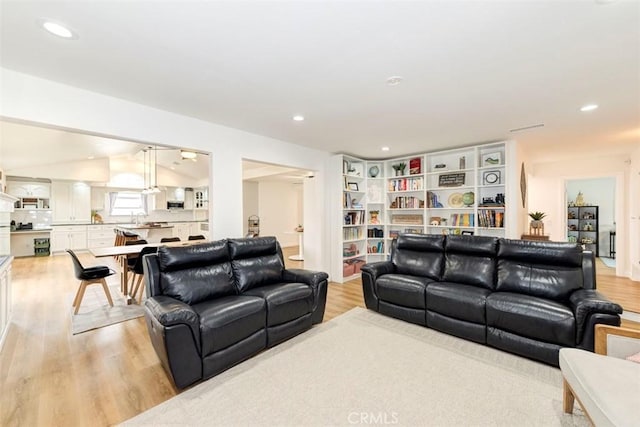 1417 E Abbottson St, Carson, CA 90746 - living area with light wood finished floors, lofted ceiling, and recessed lighting