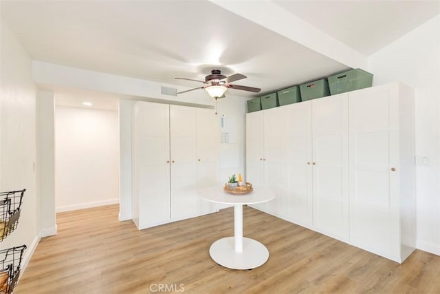 unfurnished bedroom featuring light wood-type flooring, baseboards, a closet, and a ceiling fan