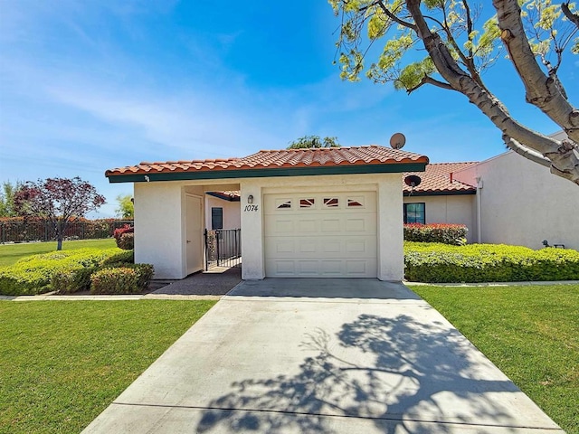 1074 Merrill Cir, Hemet, CA 92545 - mediterranean / spanish home featuring a garage, a tile roof, concrete driveway, and stucco siding